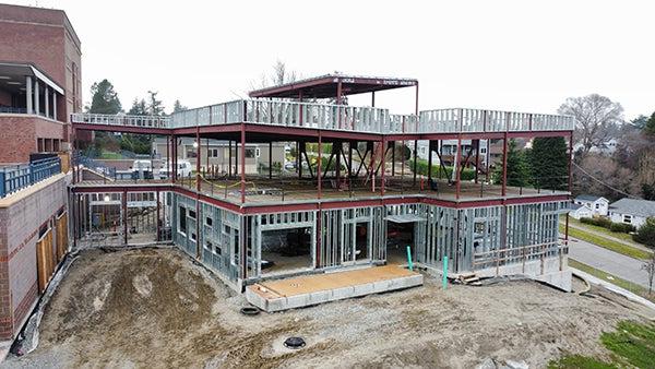 a building under construction shows steel wall supports within a structural steel frame